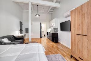 a bedroom with a bed and a couch and a tv at Trumbull Apartments Elevator WI-FI XL CENTER Hartford CT in Hartford