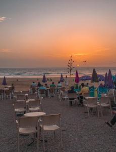 a group of tables and chairs on the beach at Dallas Surf Apartment in Agadir