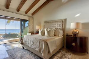 a bedroom with a bed with a view of the ocean at Luxurious 5bd Del Mar Palmilla Villa Staffed and Swimmable Beach in San José del Cabo +66 photos