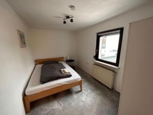 a small bedroom with a bed and a window at Zimmervermietung Hirschmann Nürnberg/Messe in Nürnberg