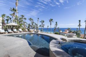 a swimming pool with a view of the ocean at Luxurious 5bd Del Mar Palmilla Villa Staffed and Swimmable Beach in San José del Cabo