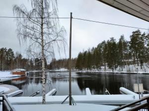a view of a river covered in snow at Ruukin Kievari Hotelli Ravintola in Juankoski