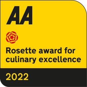 a yellow sign with a rosette award for culinary excellence at No11 Boutique Hotel & Brasserie in Edinburgh