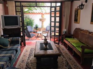 a living room with a couch and a tv at Casa Villa de Leyva in Villa de Leyva