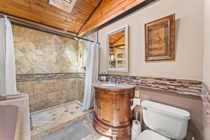 ein Bad mit einer Dusche, einem WC und einem Waschbecken in der Unterkunft Beautiful 5bd Home with Pool Near LakePoint Sports in Cartersville