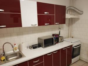 een keuken met een magnetron en een wastafel bij Central Apartment Bucharest Mall in Vitan