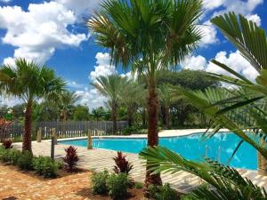 una piscina con palmeras en un complejo en Beautiful townhouse with pool close to Disney en Davenport