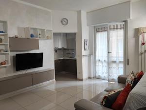 a living room with a couch and a television at da Rosa in Finale Ligure
