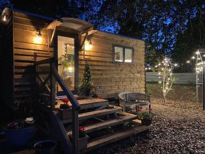 a tiny house with a christmas tree on the stairs at Cosy Double Shepherds Hut In Beautiful Wicklow With Underfloor Heating Throughout in Rathnew