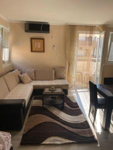 a living room with a couch and a table at Studio Apartment for rent in Budva in Budva