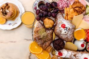 a plate of pastries and fruit on a table at B&B Palazzo Cerami in Catania