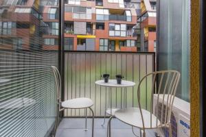 a balcony with two chairs and a table and a window at Gorgeous central flat with garage in Ljubljana