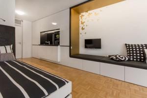a bedroom with a bed and a tv and a mirror at Gorgeous central flat with garage in Ljubljana
