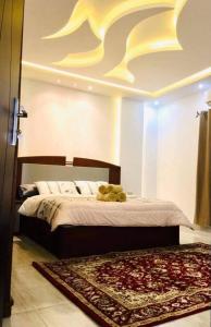 a bedroom with a large bed and a rug at Villa Sky in Hurghada