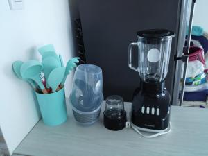 a blender on a counter with a cup of utensils at Sotavento Suites in Cartagena de Indias
