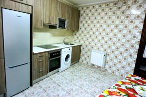 a kitchen with a white refrigerator and a dishwasher at Apartamento centro Barakaldo BEC in Barakaldo