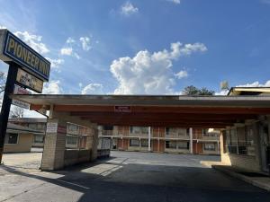 an empty gas station in front of a building at Pioneer INN in Arkadelphia