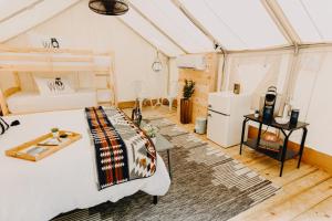 a bedroom in a greenhouse with a bed and a table at Timberline Glamping at Unicoi State Park in Helen