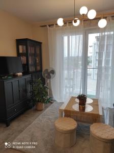 a living room with a table and chairs and a tv at Apartament na Wzgórzu Zielony in Łańcut