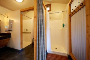 a bathroom with a shower and a toilet at Evergreen Lodge at Yosemite in Groveland