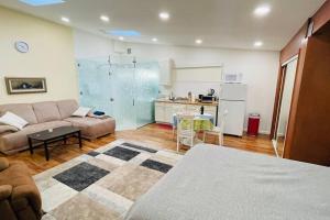 a living room with a couch and a kitchen at Mountain Lodge Estate in Los Gatos