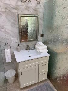a white bathroom with a sink and a mirror at Mountain Lodge Estate in Los Gatos