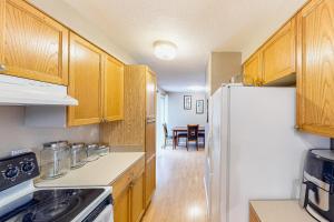 a kitchen with wooden cabinets and a white refrigerator at Livin' the Dream in Springfield