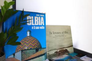 a book sitting on top of a desk next to another at Citroom - green city rooms in Olbia