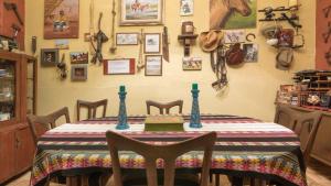 a dining room with a table with a horse on the wall at Beraja Family Hostel in Lima