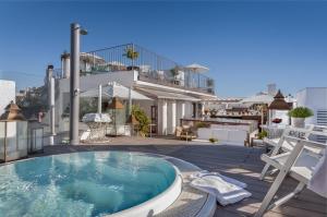 a swimming pool on the roof of a house at Hotel Amadeus Sevilla in Seville