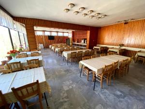 an empty dining room with tables and chairs at Penzión Jazmín in Prašice