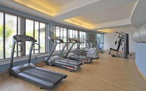 a gym with several tread machines in a room at Pestana Alvor Praia Premium Beach & Golf Resort in Alvor