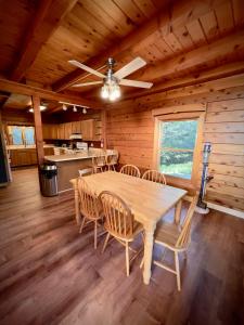 a dining room with a table and chairs in a cabin at Cabin close to Lake Willoughby and ski areas in Barton