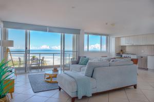 a living room with a couch and a view of the ocean at Grandview Apartments in Ballina