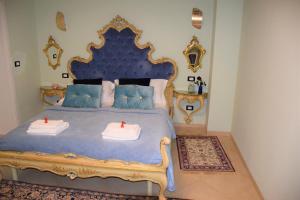 a bedroom with a blue bed with two candles on it at Le Pizzocchere in Venice