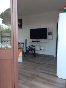 a living room with a flat screen tv on a wall at Camera Tina in Castellammare del Golfo