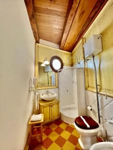 a bathroom with a toilet and a sink at Atenea Luxury Suites in Agrigento