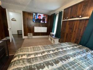 a bedroom with a bed and a tv in it at Lovely Rural 1 Bedroom Apartment in St Mary’s in Saint Marys