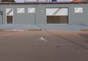 an empty parking lot with three garage doors on a building at L & C - Casa por Temporada in Macapá