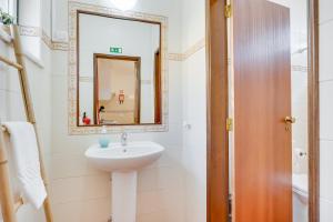 a bathroom with a sink and a mirror at Lugar do Regato - Alojamento Local in Portel