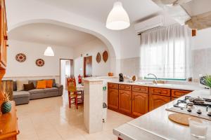 an open kitchen and living room with a couch at Lugar do Regato - Alojamento Local in Portel +29 photos