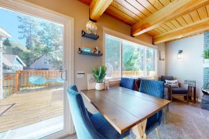 a dining room with a wooden table and blue chairs at Hemlock Haven in Lake Arrowhead