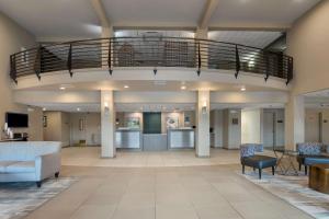 a large lobby with a staircase in a building at Best Western Plus Chena River Lodge in Fairbanks