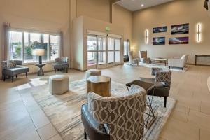 a lobby with couches and chairs in a building at Best Western Plus Chena River Lodge in Fairbanks