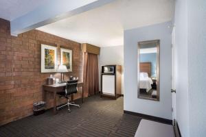 a hotel room with a bathroom with a sink and a mirror at Best Western Pocatello Inn in Pocatello