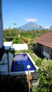 a swimming pool in the middle of a yard at BALI AMED FEEL HOME VILLA in Amed
