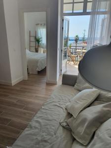 a living room with a couch and a bedroom at Rosamar 211 Los Cristianos Ocean Views in Arona