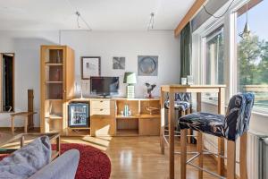 a living room with a couch and a tv at Best Western Hotel Norra Vattern in Askersund