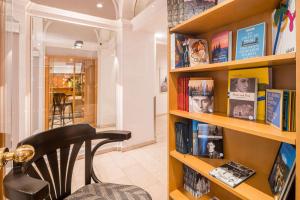 a chair sitting in front of a book shelf at Best Western Hotel Moran in Prague