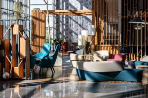 a lobby with colorful chairs and tables at Radisson Blu Hotel Lietuva in Vilnius